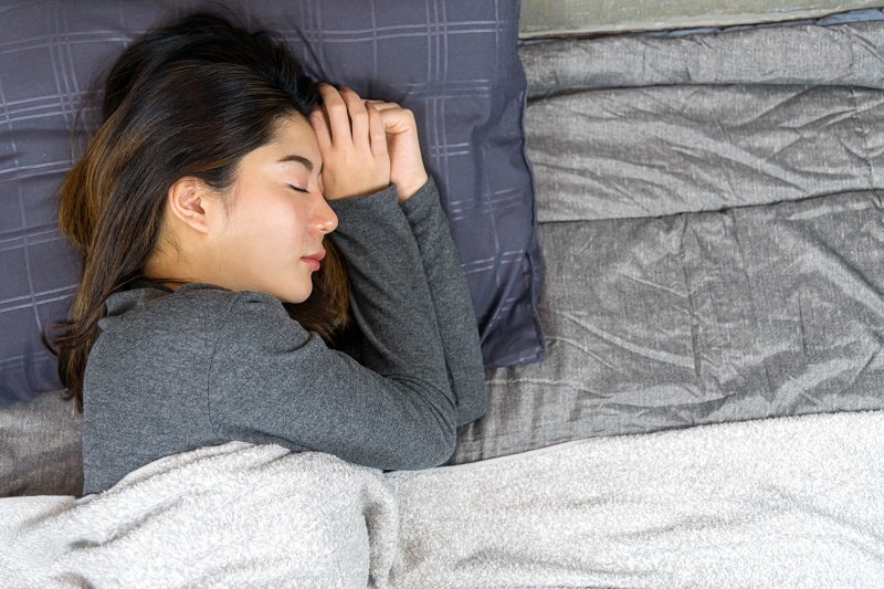 Woman sleeping on side after breast reconstruction