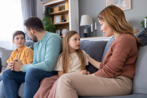 Parents having an age-appropriate conversation with their children about a breast cancer diagnosis and upcoming treatment.