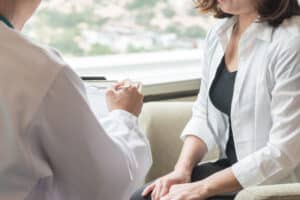 Woman in consultation with doctor for breast reconstruction.